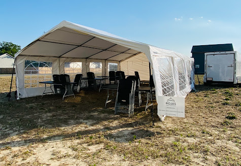 Rojas Party Rental white tent setup with tables and chairs